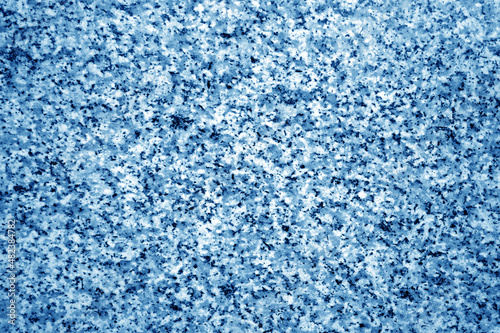Granite surface as background with blur effect in navy blue tone.