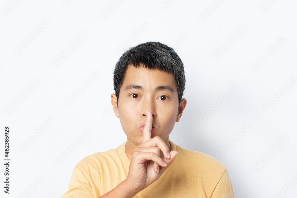 man making hush gesture and keep conspiracy isolated on white background. man making hush gesture and keep conspiracy isolated on white background.
