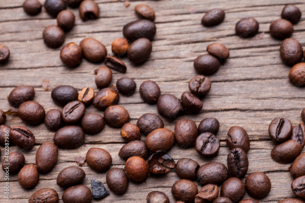 Coffee beans on old wooden floor background.. Coffee beans on old wooden floor background..