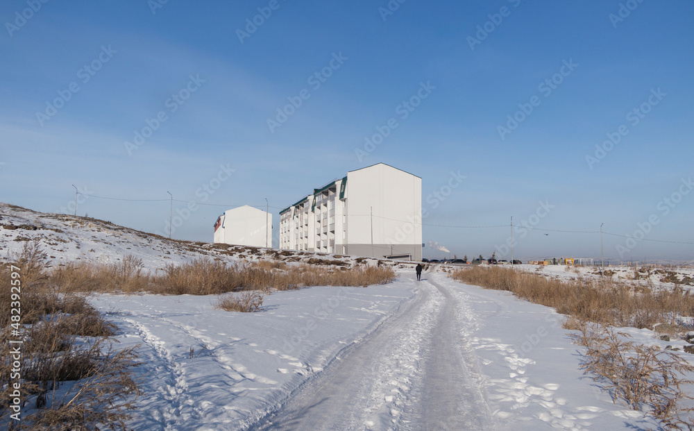 Modern apartment buildings. kazakhstan (Ust-Kamenogorsk). New residential area. Contemporary architecture. Blue Sky and White snow. New Houses. City street Modern apartment buildings. kazakhstan (Ust-Kamenogorsk). New residential area. Contemporary architecture. Blue Sky and White snow. New Houses. City street