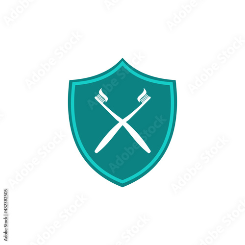 Dent protection. Protection of teeth and oral cavity. Shield and crossed toothbrushes. Guard your teeth. Dental shield Logo. Vector illustration isolated on white background
