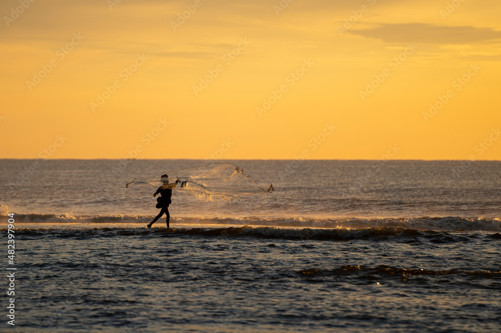 a fisherman casting net