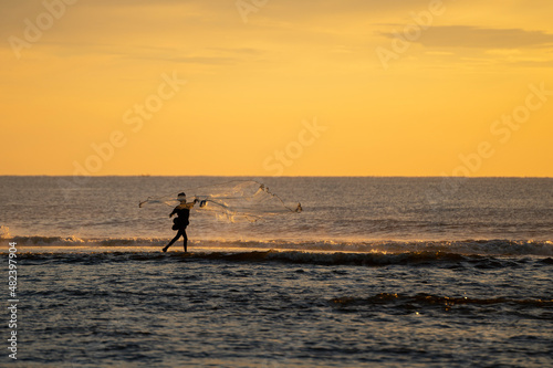 a fisherman casting net © aadhithan
