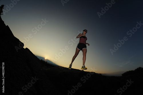 Woman jogger over lava field, Big Island, Hawaii, USA, MR