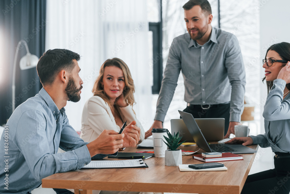 Having conversation. Group of business people that working on the project in the office Having conversation. Group of business people that working on the project in the office