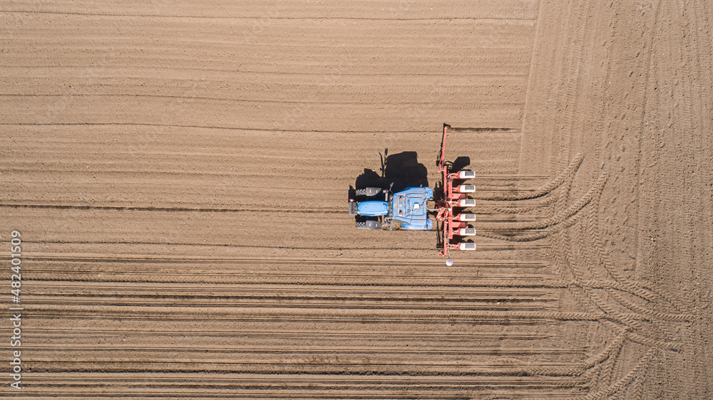 Aerial view of tractor sowing in agriculture area