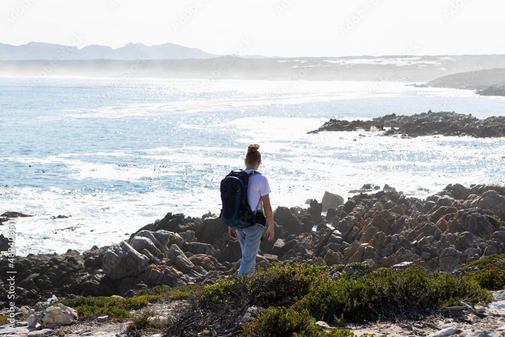 teenage girl and younger brother hiking the De Kelders coastal trail, South Africa teenage girl and younger brother hiking the De Kelders coastal trail, South Africa