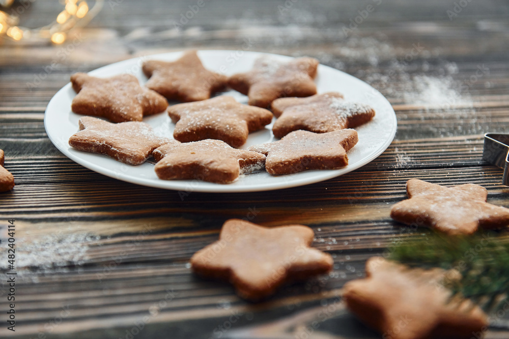 Fototapeta premium Cookies is on the plate. Christmas background with holiday decoration