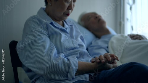 Asian senior admid sick in hospital bed wife sad and worry about husband illness disease