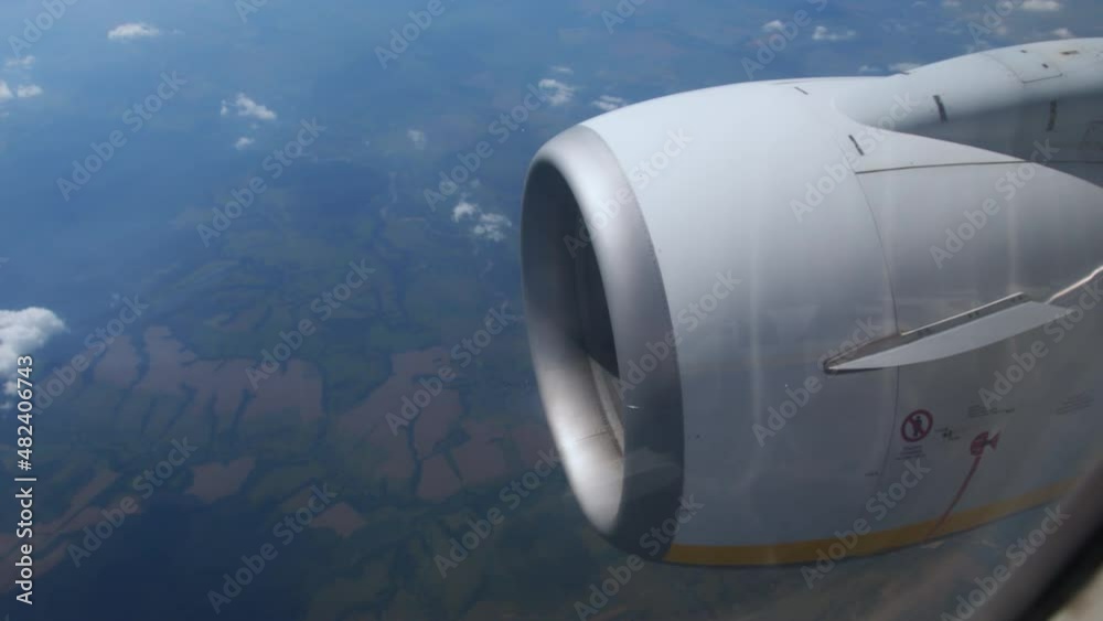 Clouds float across sky at high altitude. Flight above ground. Travel to distant countries. View of the turbine of the aircraft and the off on runway. airplane in flight, view from plane window Clouds float across sky at high altitude. Flight above ground. Travel to distant countries. View of the turbine of the aircraft and the off on runway. airplane in flight, view from plane window