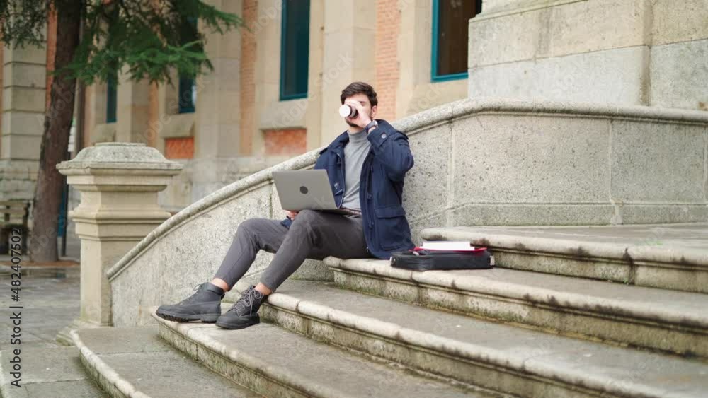 Man using laptop and drinking takeaway coffee Man using laptop and drinking takeaway coffee