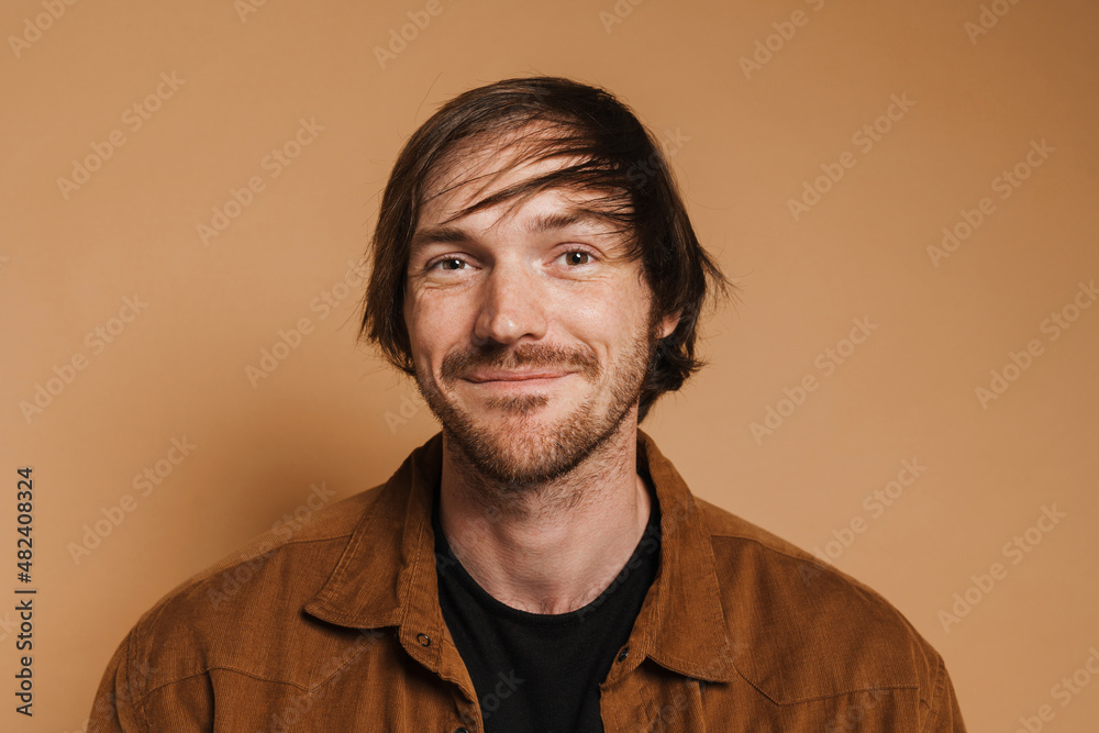 Fototapeta premium White unshaven man in shirt smiling and looking at camera