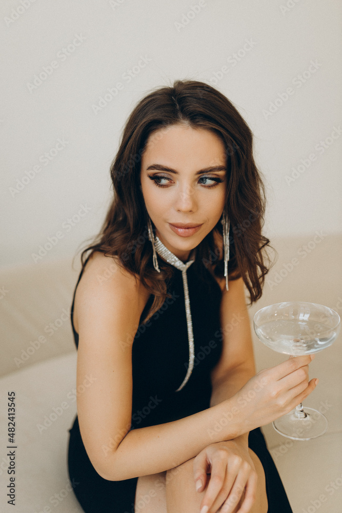 Girl dressed up with champagne in anticipation of the new year Girl dressed up with champagne in anticipation of the new year