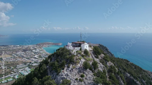 Smooth aerial footage of a church on top of a mountain. Temple of Tsambika in Greece. HDR video photo