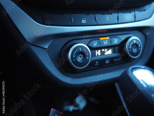 Climate controls in a car close-up. Snowflake icon on the control wheel. Air conditioning, climate control. © pattern43