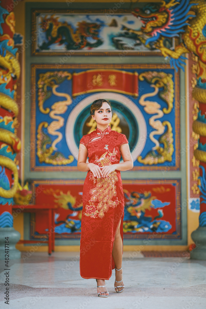 Beautiful Asian Chinese Woman Wearing Cheongsam Traditional Red Dress Fashion Posting Chinese Lunar New Year.