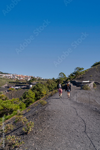 two tourists walking in the volcano of San Antonio, La Palma, Canary Islands