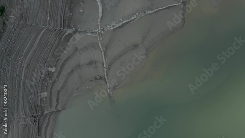 Aerial bird's eye view of layers of silt deposition by the lake Ayous in autumn season in the Pyrenees in France. photo