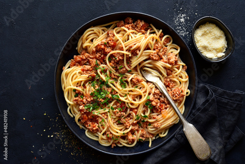 Traditional italian spaghetti bolognese with minced meat and tomato sauce. Top view with copy space.