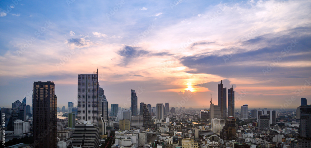 Fototapeta premium Cityscape of modern buildings and urban architecture. Aerial view of Bangkok city at twilight sunset in Thailand.