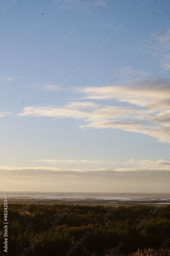 Sunrise at Beach with Dunes Ocean and Sky