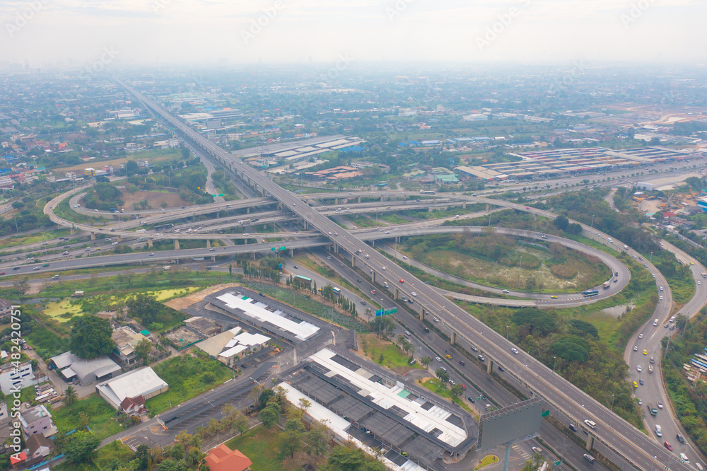 Aerial view of cars driving on highway or moterway. Overpass bridge street roads in connection network of architecture concept. Top view. Urban city, Bangkok, Thailand.