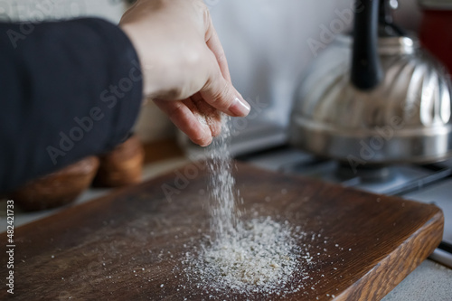Girl pours salt on the table