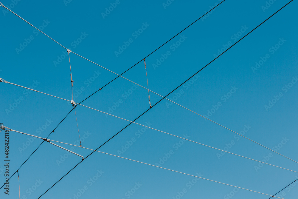 Power line wires against the blue sky. - obrazy, fototapety, plakaty 