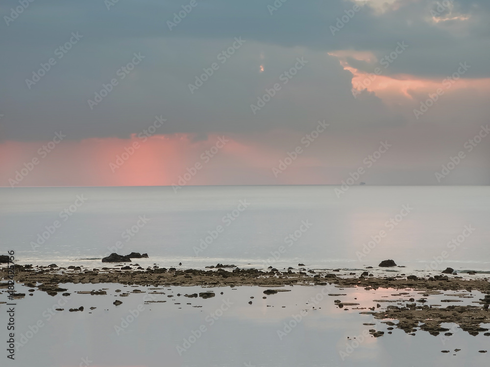 Beautiful Beach background. sunset time with sand tree and dead corals. Peaceful place to see view side