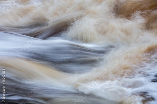 Close up of water flowing over rocks; long exposure image