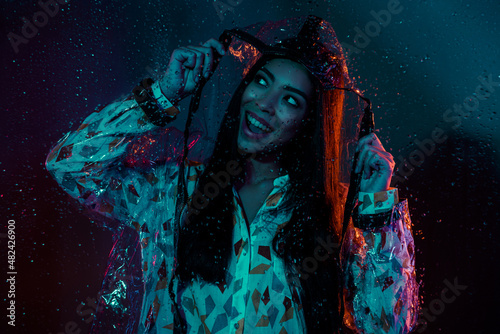 Photo of funky lady wear plastic jacket stroll rainy weather isolated dark cyber effect colorful background