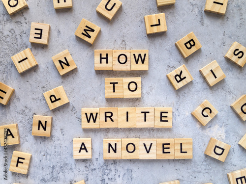 Top view of words HOW TO WRITE A NOVEL made from wooden letters. Frame made of letters.