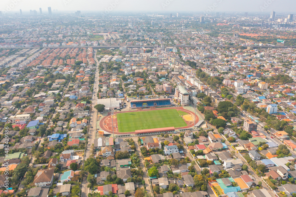 Aerial top view of soccer football sport recreation field ground, national stadium. Urban city town in Asia. Green court arena.