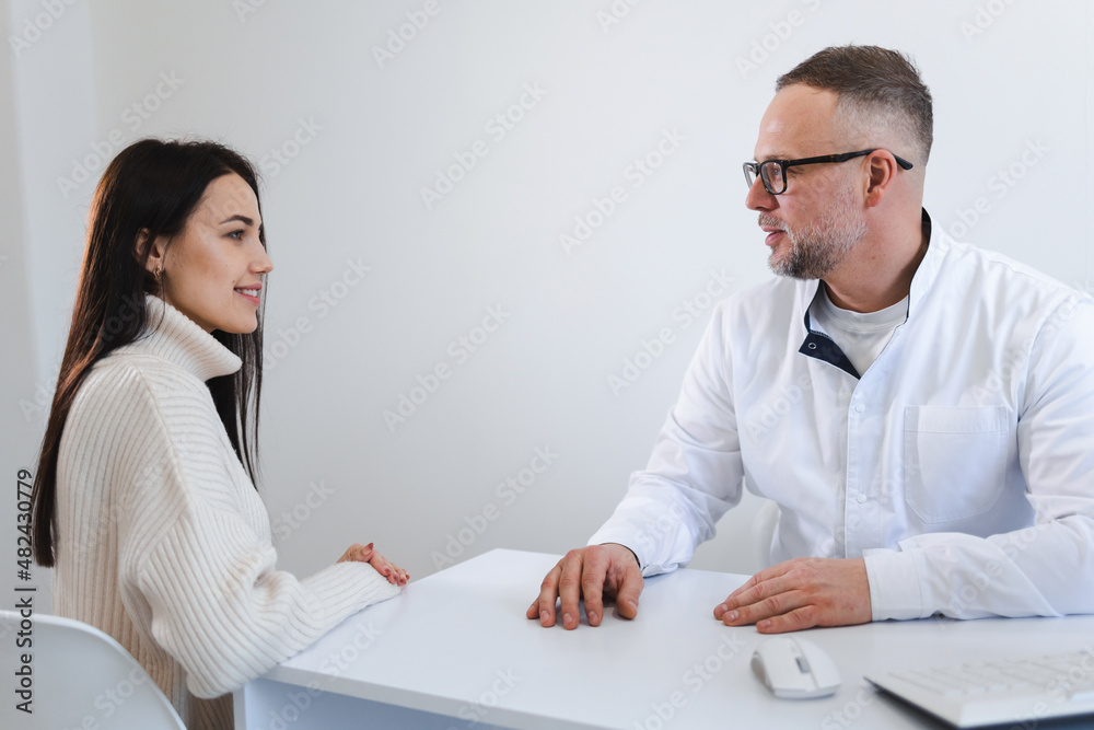 Dialogue between doctor and patient. Woman at a therapist's appointment Dialogue between doctor and patient. Woman at a therapist's appointment