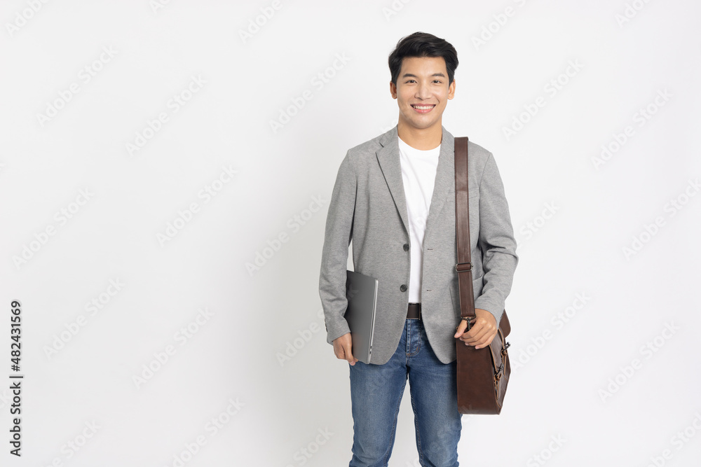 Portrait of young Asian businessman holding laptop and brown leather bag isolated on white background Portrait of young Asian businessman holding laptop and brown leather bag isolated on white background