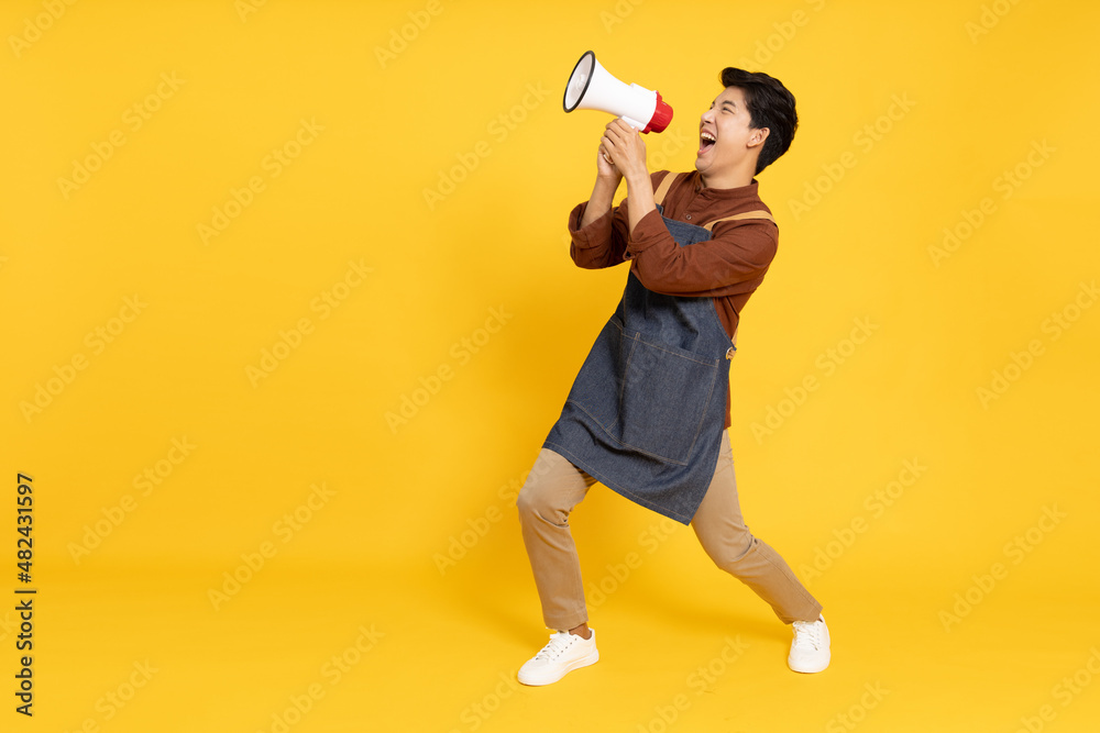 Restaurant owner sme young Asian man holding megaphone isolated on yellow background, Speaker and announce concept Restaurant owner sme young Asian man holding megaphone isolated on yellow background, Speaker and announce concept
