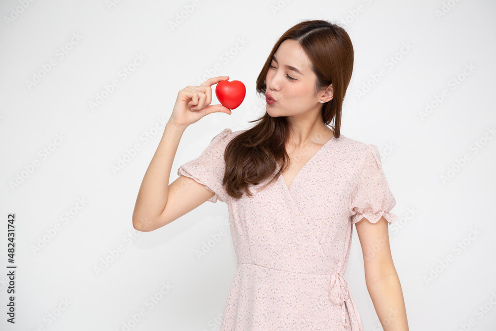 Young Asian woman holding red heart isolated on white background Young Asian woman holding red heart isolated on white background