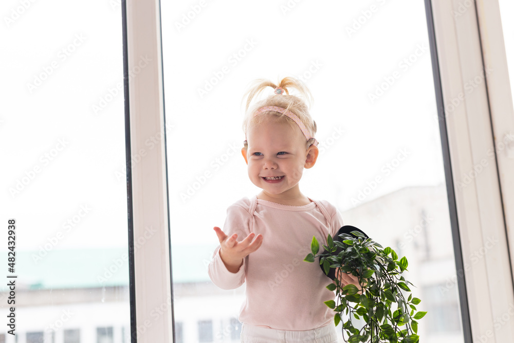 Baby with cochlear implants having fun at home. Deafness and medical technology concept. Baby with cochlear implants having fun at home. Deafness and medical technology concept.