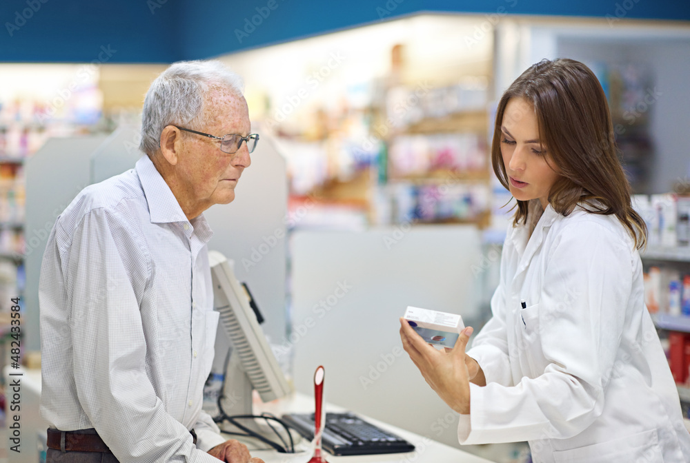 Filling prescriptions and customer's needs. Shot of a young pharmacist helping an elderly customer at the prescription counter. Filling prescriptions and customer's needs. Shot of a young pharmacist helping an elderly customer at the prescription counter.