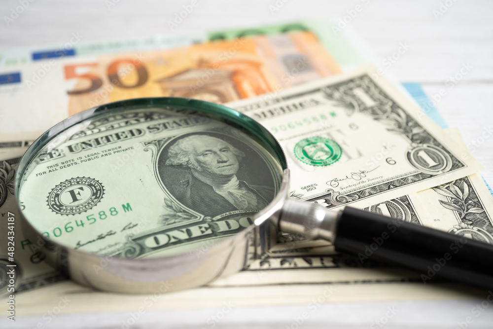 Magnifying glass with EU and US dollar banknotes background, Banking Account, Investment Analytic research data economy, trading, Business company concept. Magnifying glass with EU and US dollar banknotes background, Banking Account, Investment Analytic research data economy, trading, Business company concept.