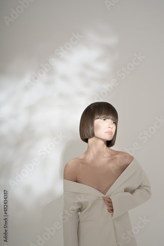 Fotobehang Beautiful brunette with graphic bob haircut wear white fashion jacket