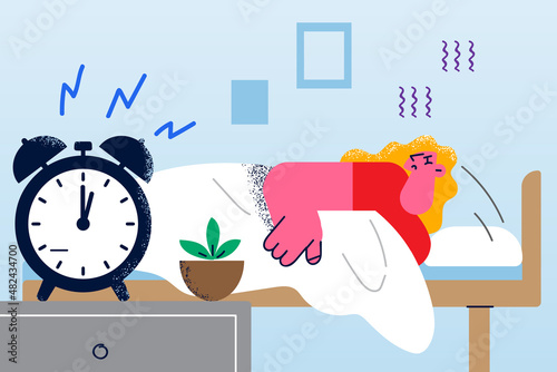 Exhausted woman sleep in bed unable wakeup 
