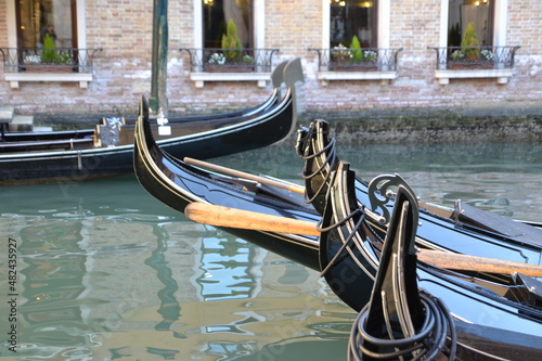 canal in venice, italy, with old buildings on the side, in a gondola ride, in blue tones, reflection in the water