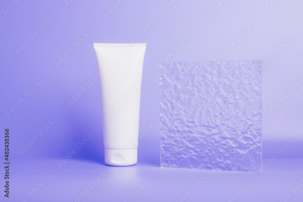 Cosmetic product in a tube, white container purple background. Shampoo, hand cream, toothpaste white packaging Cosmetic product in a tube, white container purple background. Shampoo, hand cream, toothpaste white packaging
