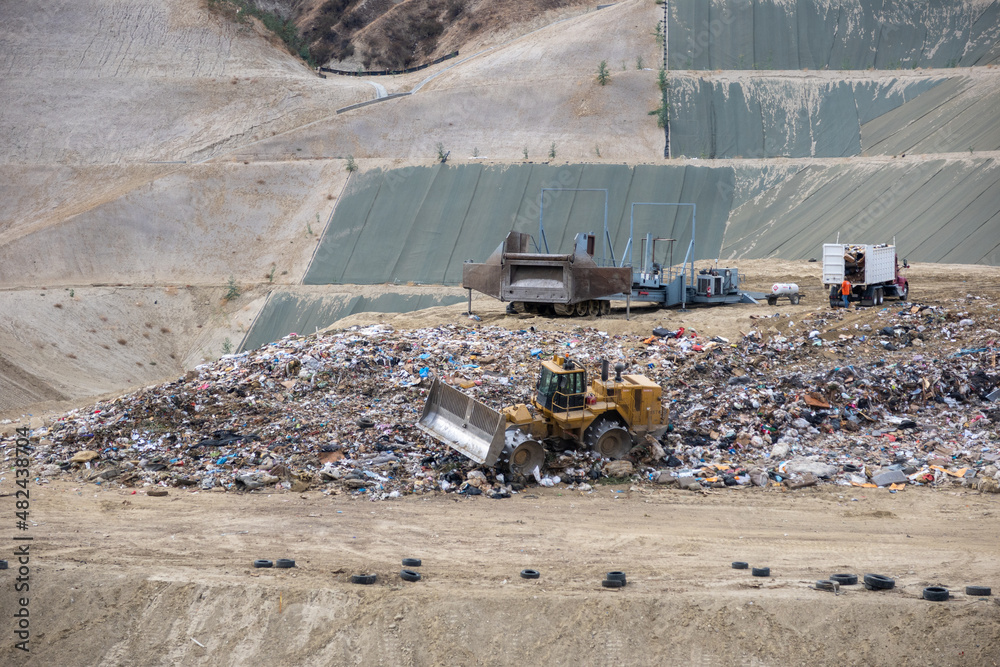 A Sanitary Landfill Site used to Manage Waste looking at a Bulldozer