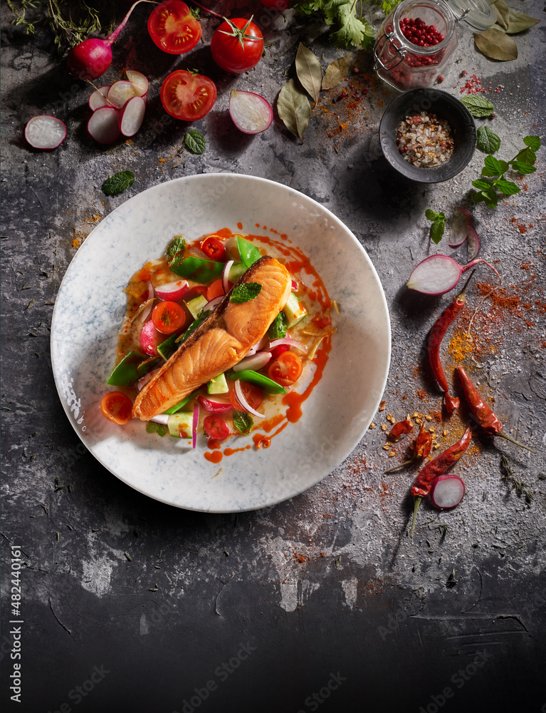 Grilled salmon with vegetables on a decorated background Grilled salmon with vegetables on a decorated background