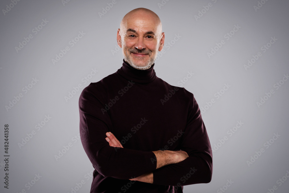 Fototapeta premium Smiling middle aged man wearing casual clothes while standing at isolated background