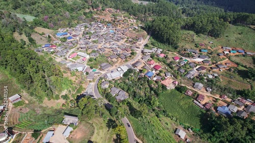 Aerial view of traditional local tribe village neightborhood in the valley surrounded by tropical rainforest at countryside photo