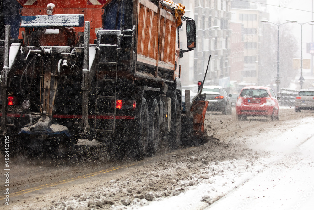 Snow plow truck cleaning streets from heavy snowfall. Snow plow truck cleaning streets from heavy snowfall.