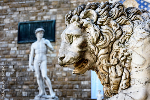 Statue of lion at Loggia Dei Lanzi in front of Florence Palazzo Vecchio and statue of David in Florence, Italy. Architecture and landmark of Florence, postcard of Florence. photo